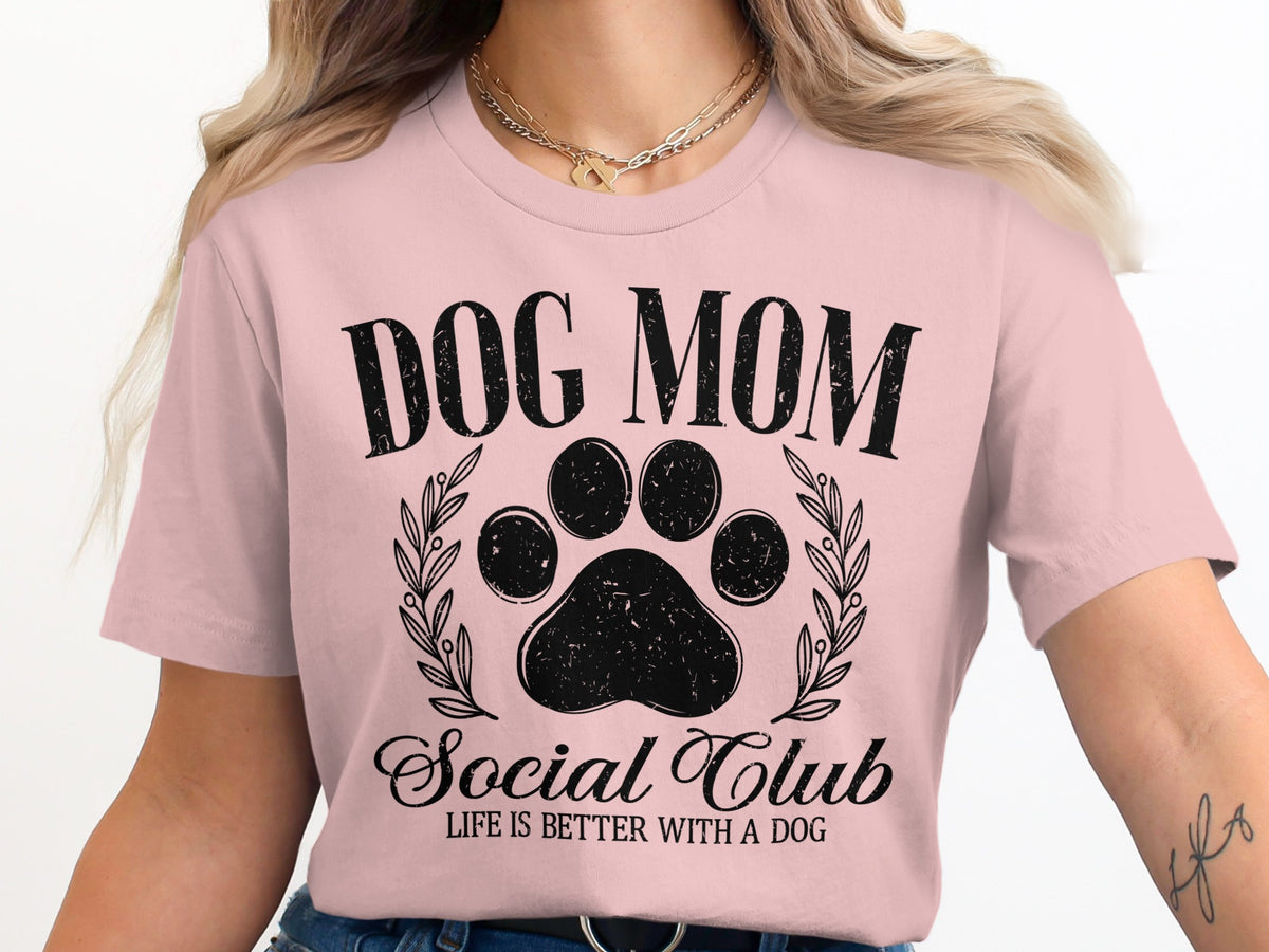 Pink t-shirt with black text "Dog Mom Social Club" and a paw print.