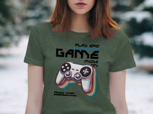 Green t-shirt with "PLAY EPIC GAME MODE ON! PRESS START" and a colorful video game controller.