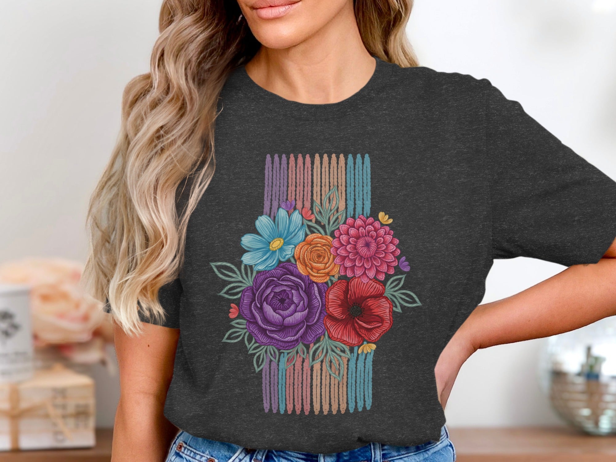 Dark grey t-shirt with colorful floral bouquet design over striped background colors.