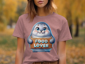 Cute seal on pink t-shirt holding a wooden sign that reads "FOOD LOVER"