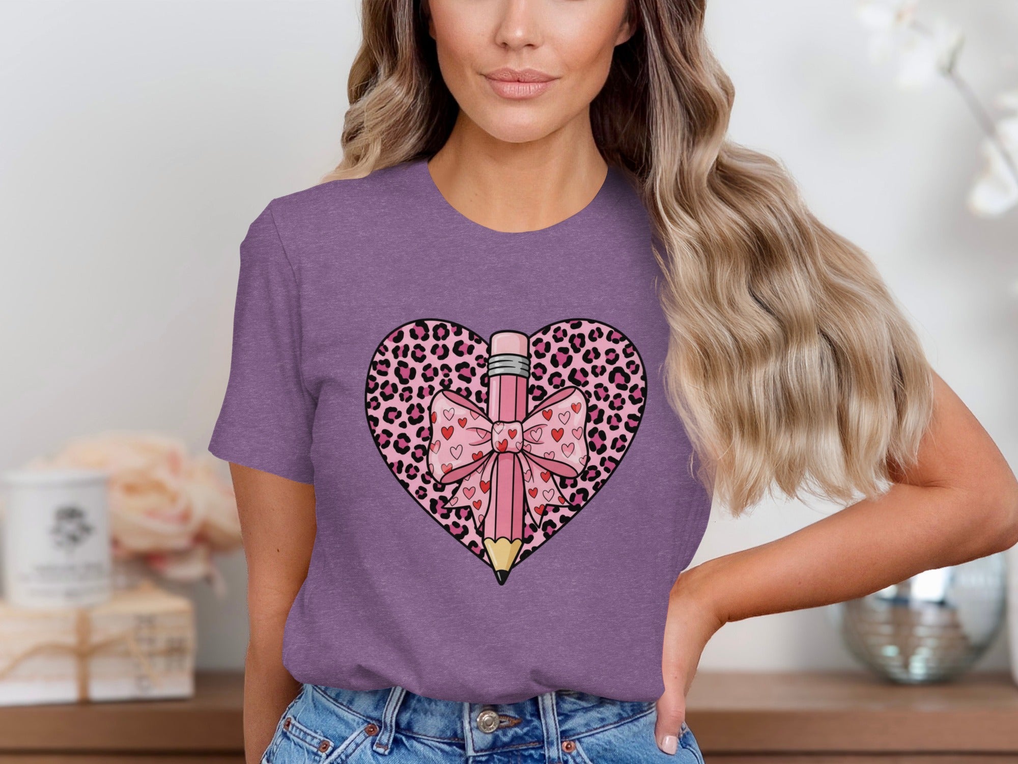 Purple t-shirt with leopard print heart graphic and pink pencil with bow and hearts.