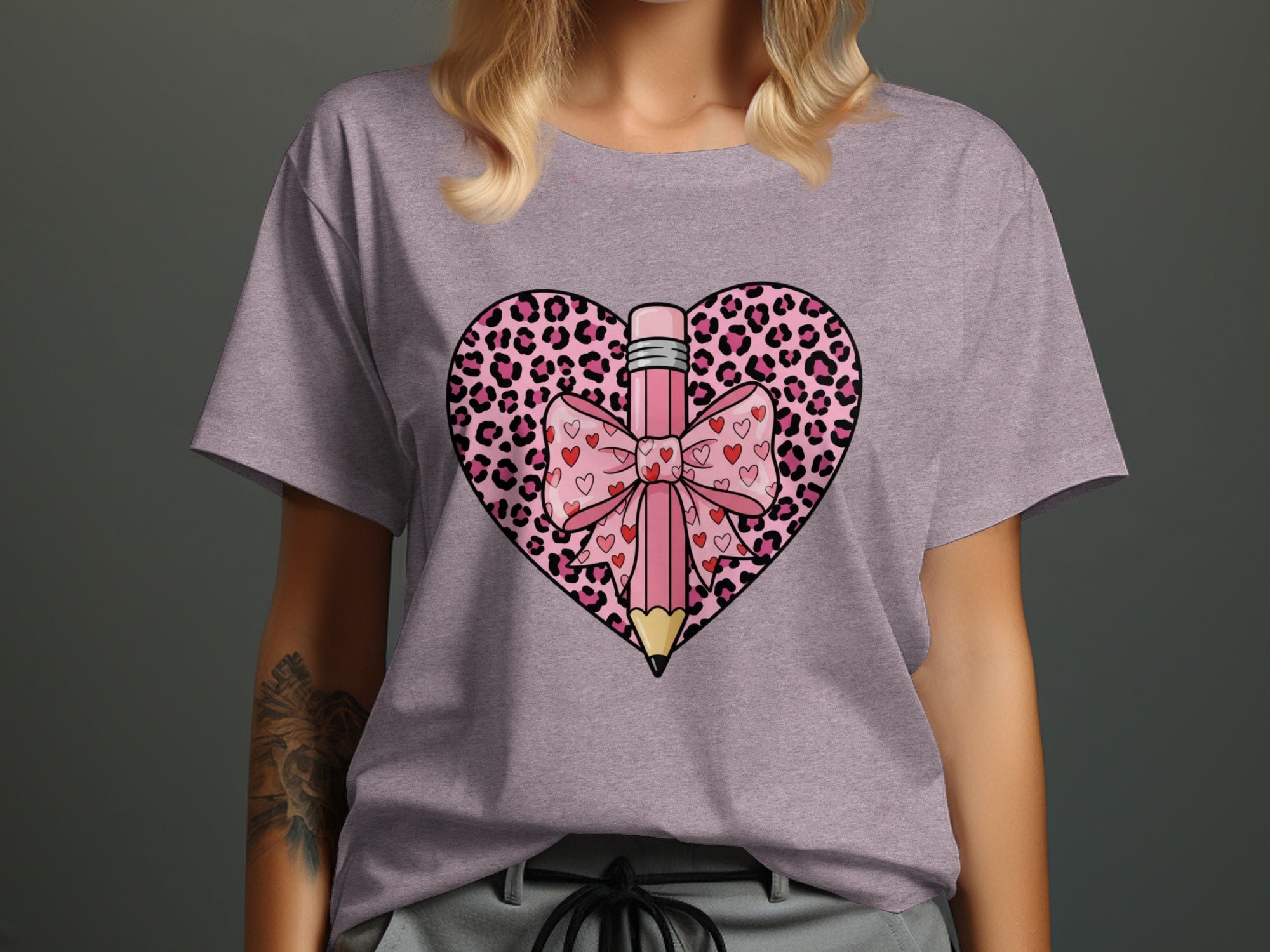Pink pencil and bow graphic on a heart with leopard print and small hearts.