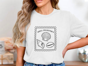 White t-shirt with a stamp design featuring three shells and text.