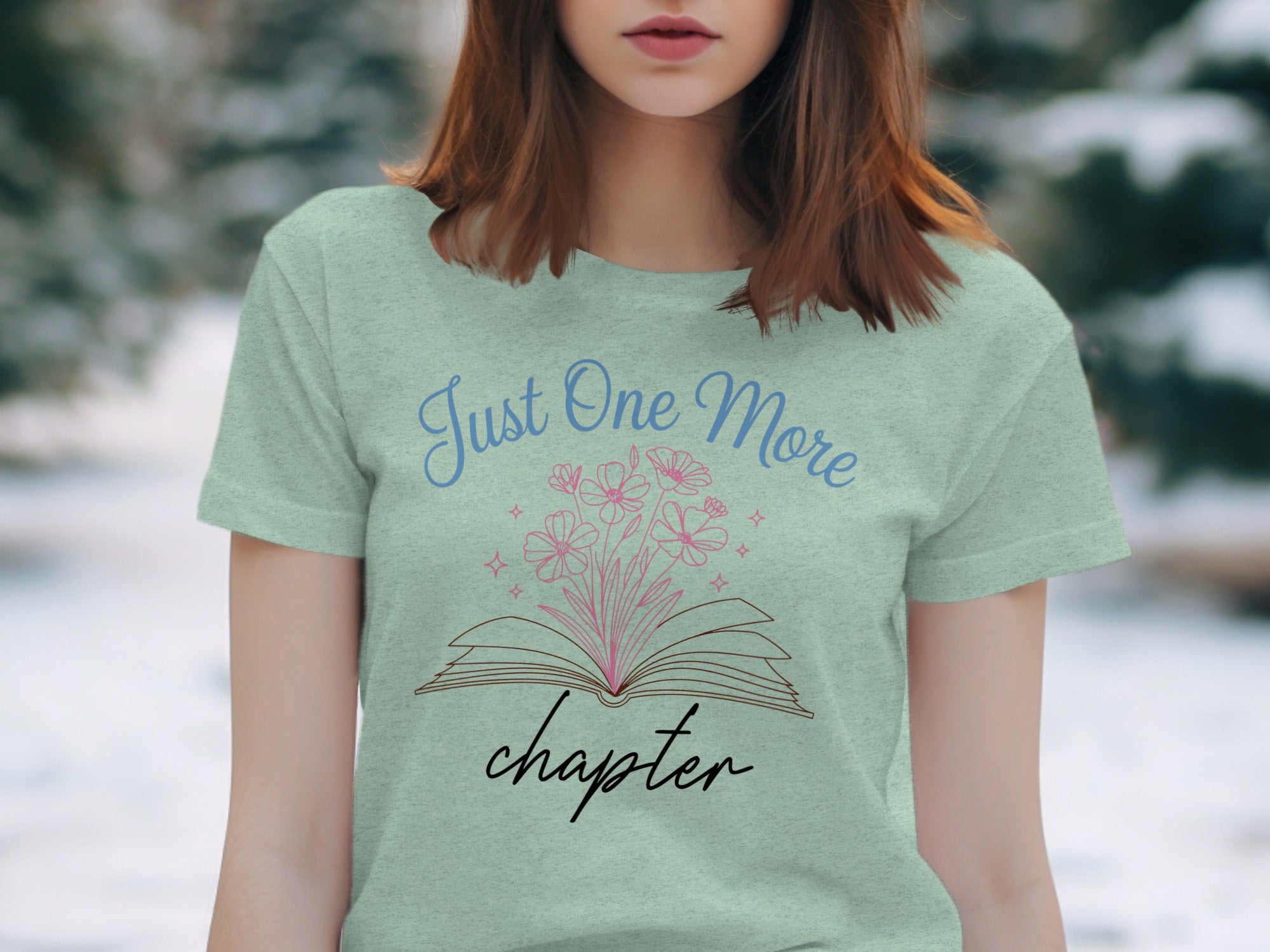 Light green t-shirt graphic with open book and "Just One More chapter" text.