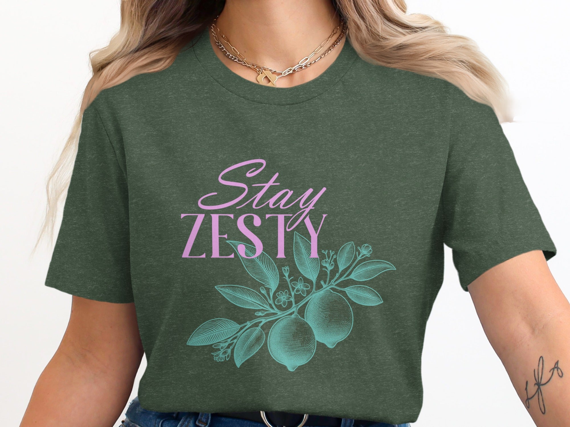 Green t-shirt with "Stay Zesty" text and lemon branch illustration.