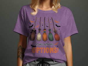 Purple t-shirt with five brooms, bats, and stars, reads "A girl's gotta have OPTIONS!"