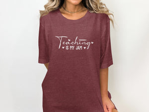 Maroon t-shirt with white text "Teaching is my jam" and small heart accents.