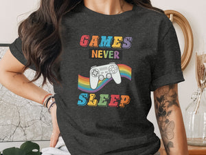 Dark t-shirt with rainbow controller graphic and text "GAMES NEVER SLEEP".