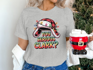 Gray t-shirt with a buffalo plaid hat and Christmas lights, reads "You Serious Clark?".