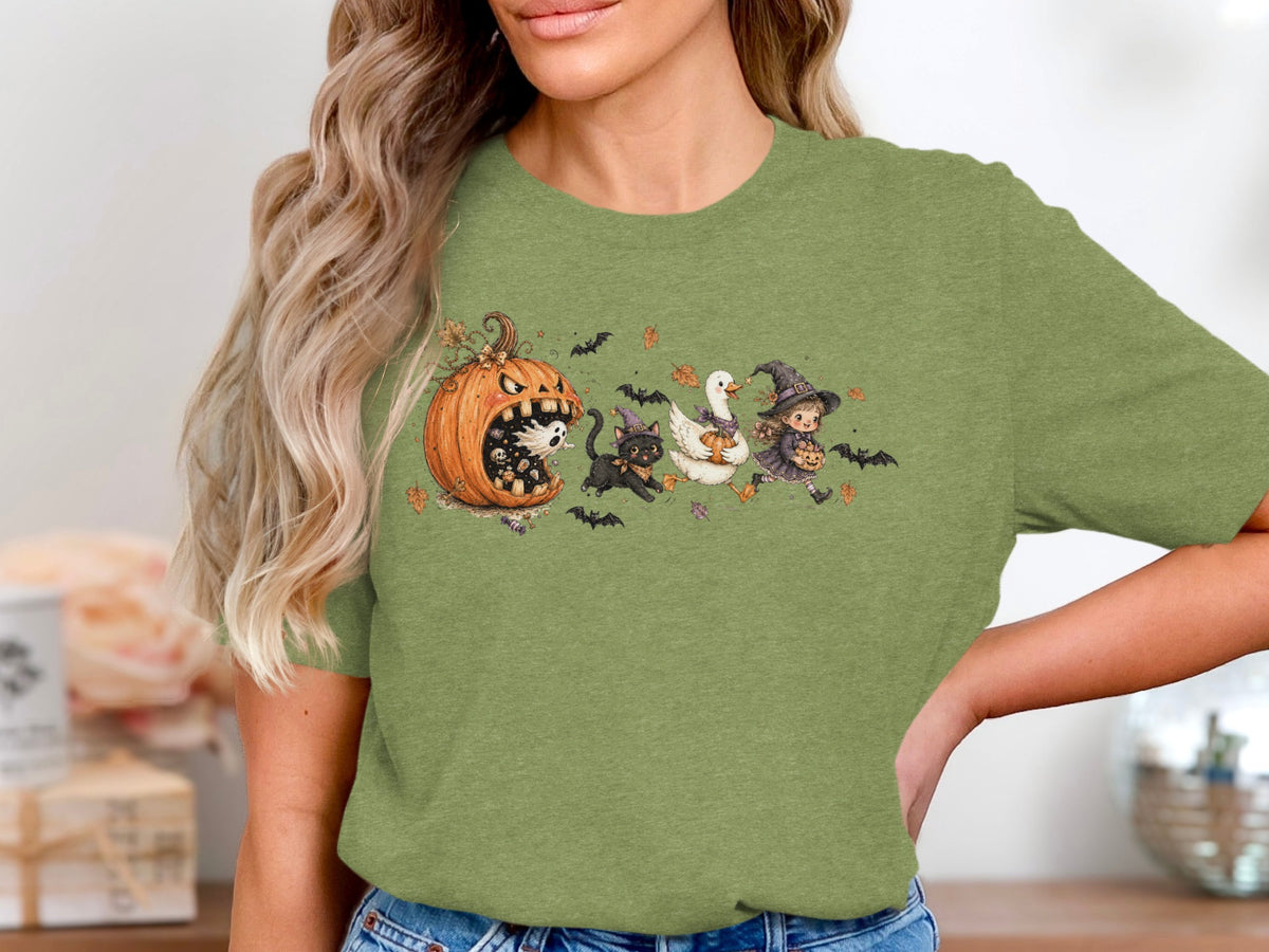 Halloween cartoon with a pumpkin, ghost, black cat, goose, and witch on a green shirt.