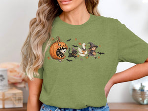 Halloween cartoon with a pumpkin, ghost, black cat, goose, and witch on a green shirt.
