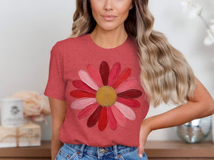 Coral t-shirt with a multi-toned pink and red flower graphic.