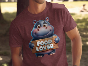 Cartoon hippo on maroon t-shirt holding wooden sign reading "Food Lover."