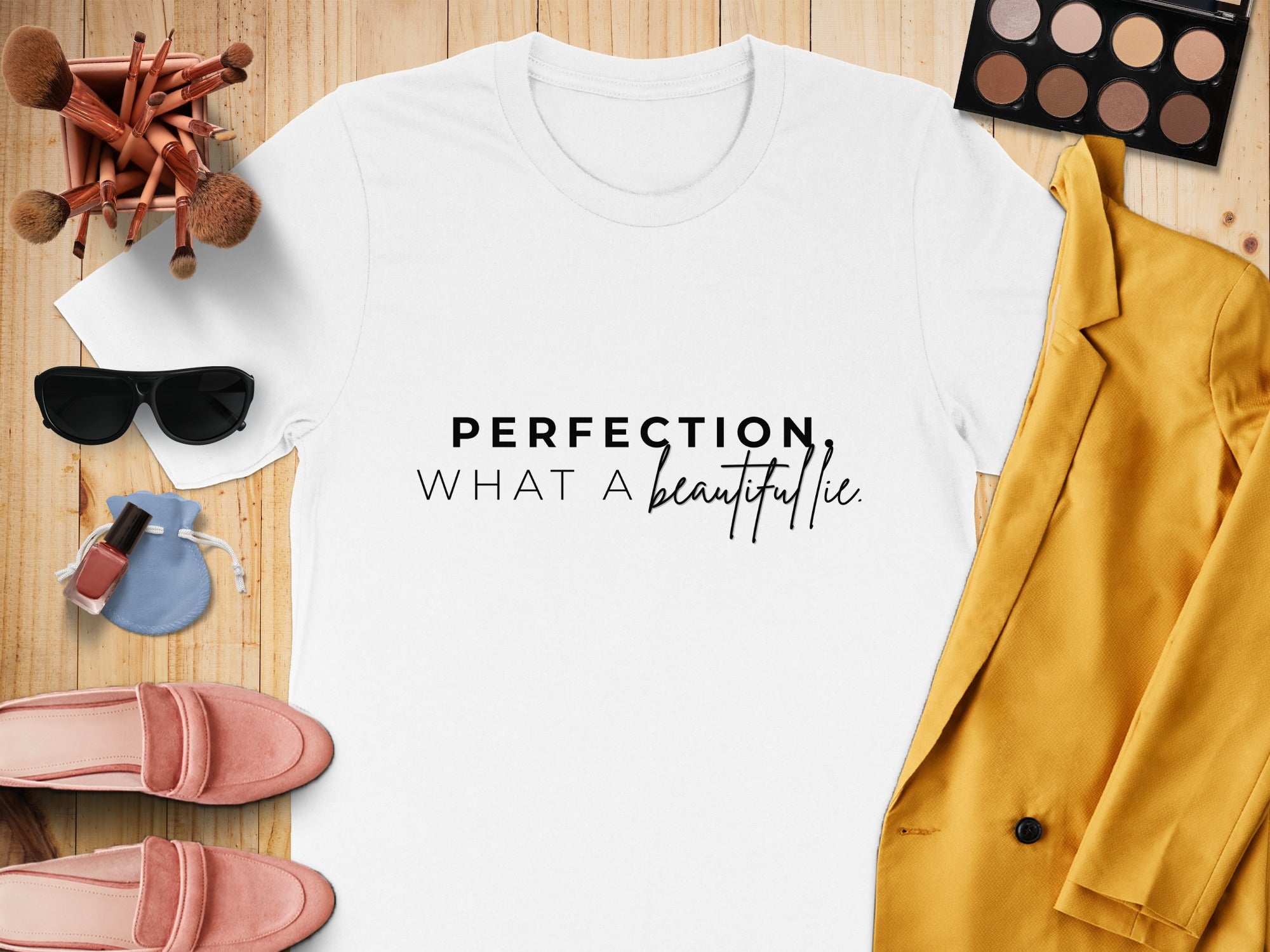 White t-shirt with black text "PERFECTION, WHAT A beautiful lie."