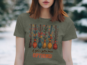 T-shirt with colorful brooms, leaves, and flowers, says "A girl's gotta have OPTIONS!"