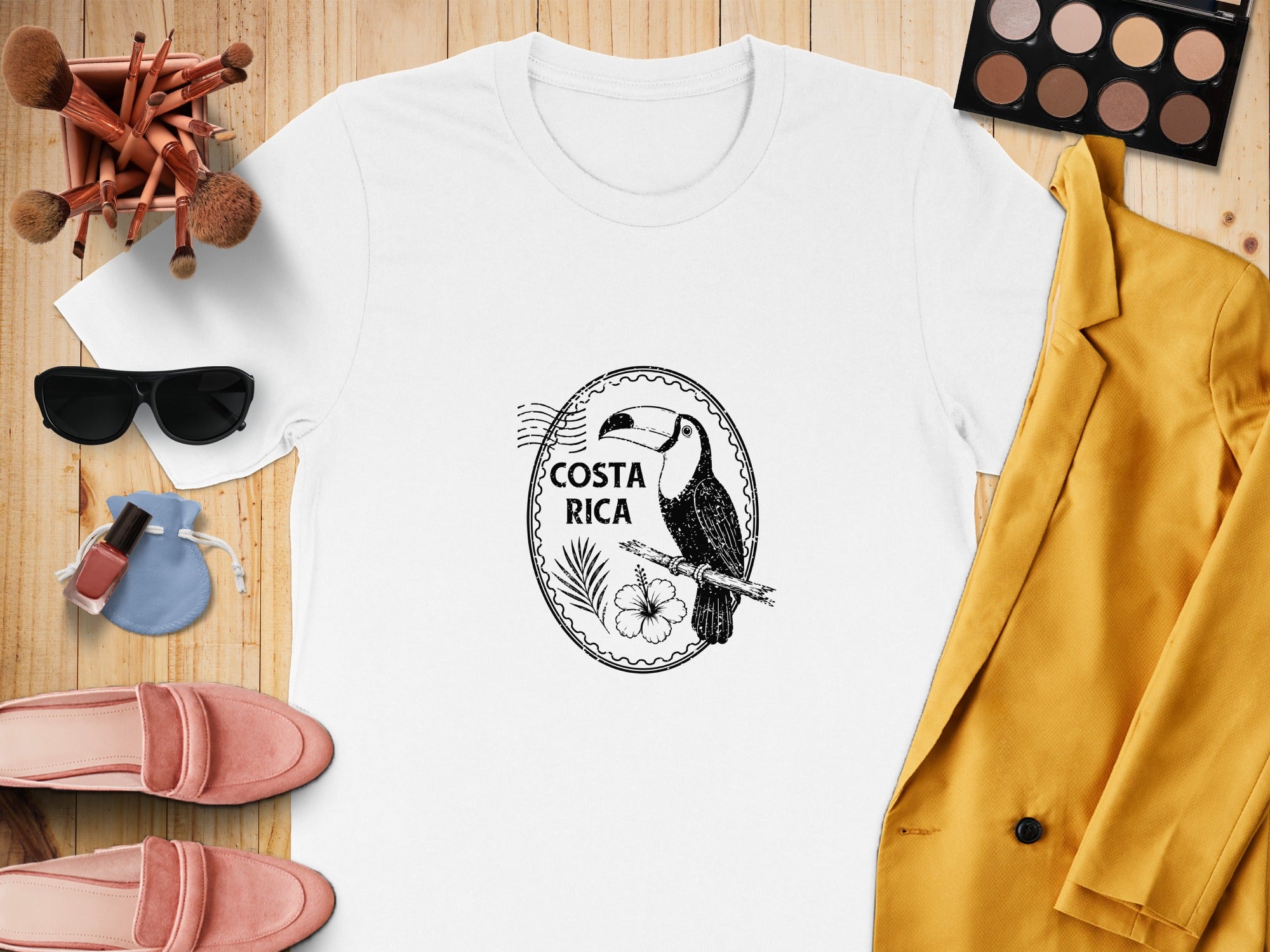 White t-shirt with Costa Rica toucan graphic, hibiscus flower, and palm frond.