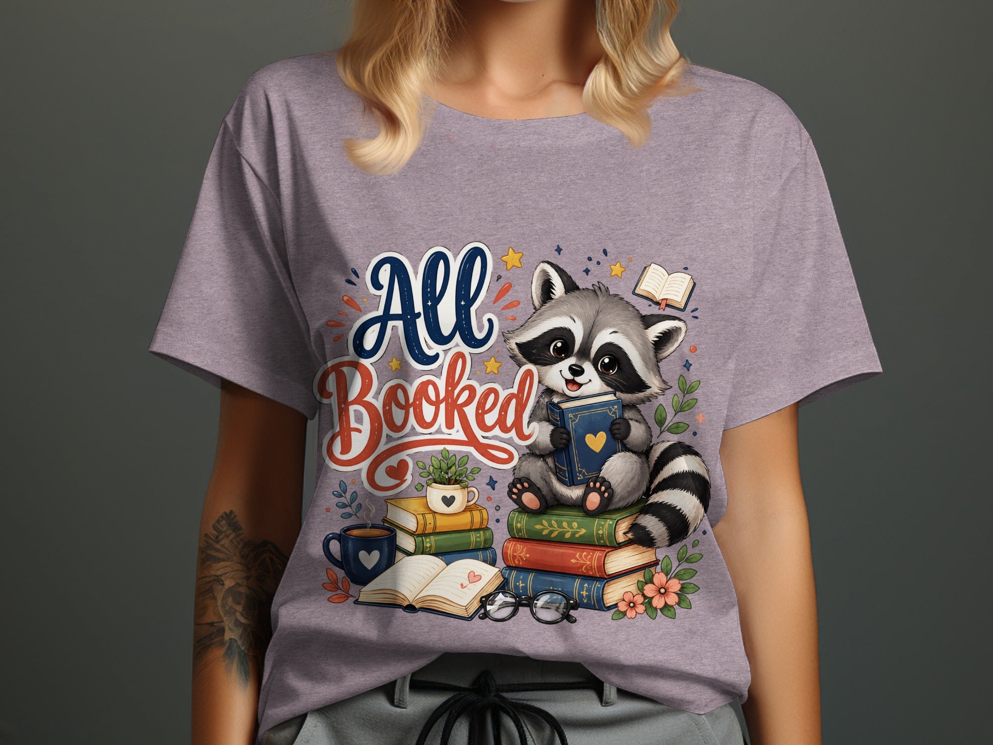 Raccoon sitting on books with "All Booked" text and a coffee mug.
