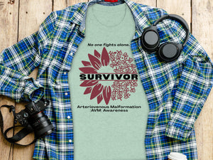Light green t-shirt displaying a sunflower design with the word SURVIVOR and AVM Awareness text.