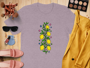 Lavender t-shirt with a lemon branch graphic, surrounded by fashion items.