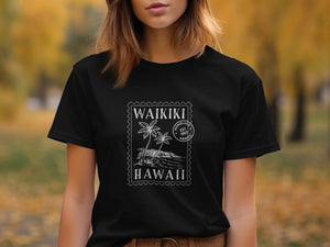 Black t-shirt with white Waikiki beach graphic and Honolulu est 1907 text.