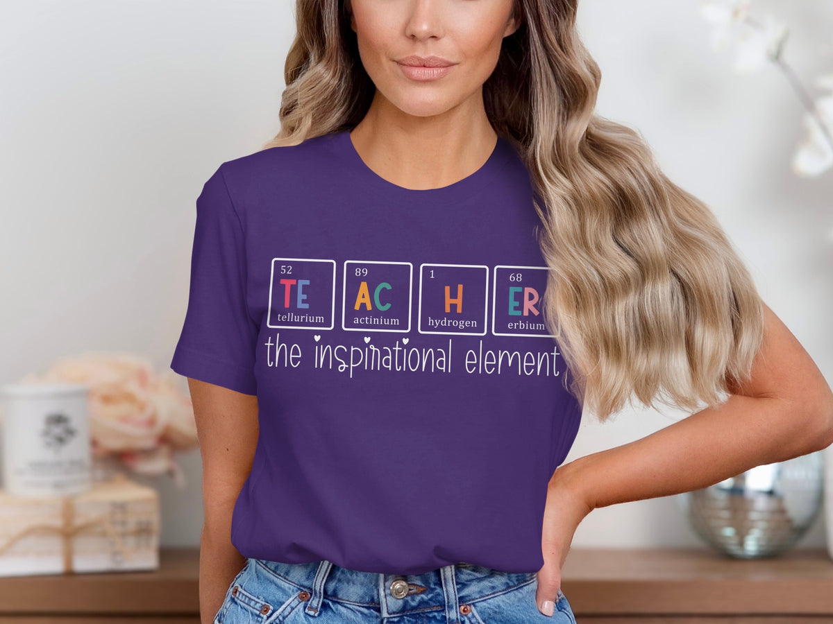 Purple t-shirt with periodic table elements spelling TEACHER and phrase "the inspirational element".