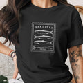 Black t-shirt with a postage stamp design featuring three sardines and "Sardines, Lisbon Fish Market, Portugal" text.