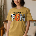 Yellow t-shirt with black text "KEEP IT" and stylized letters F-U-N.