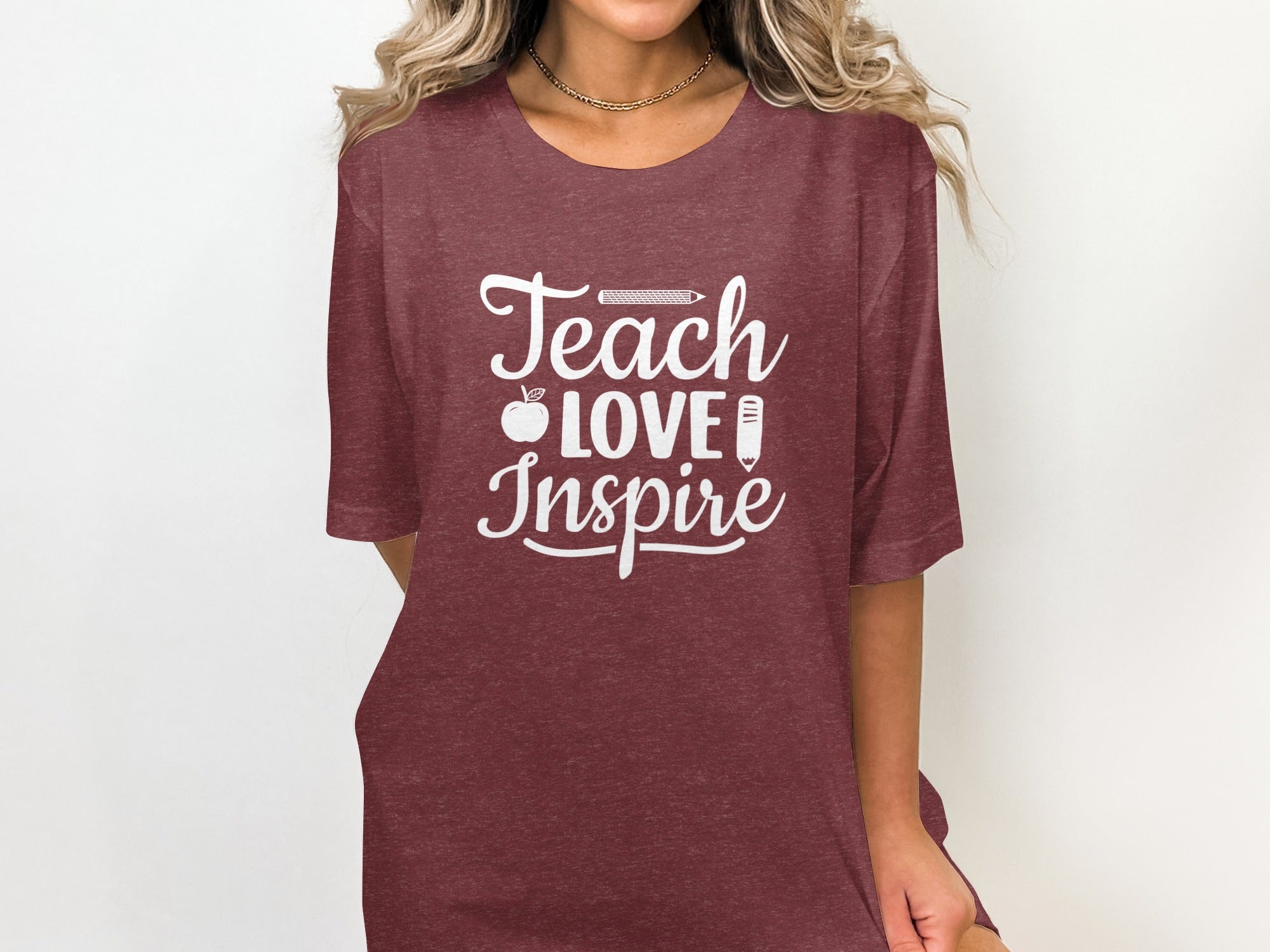 Maroon t-shirt with white text "Teach LOVE Inspire" and apple/pencil graphics.