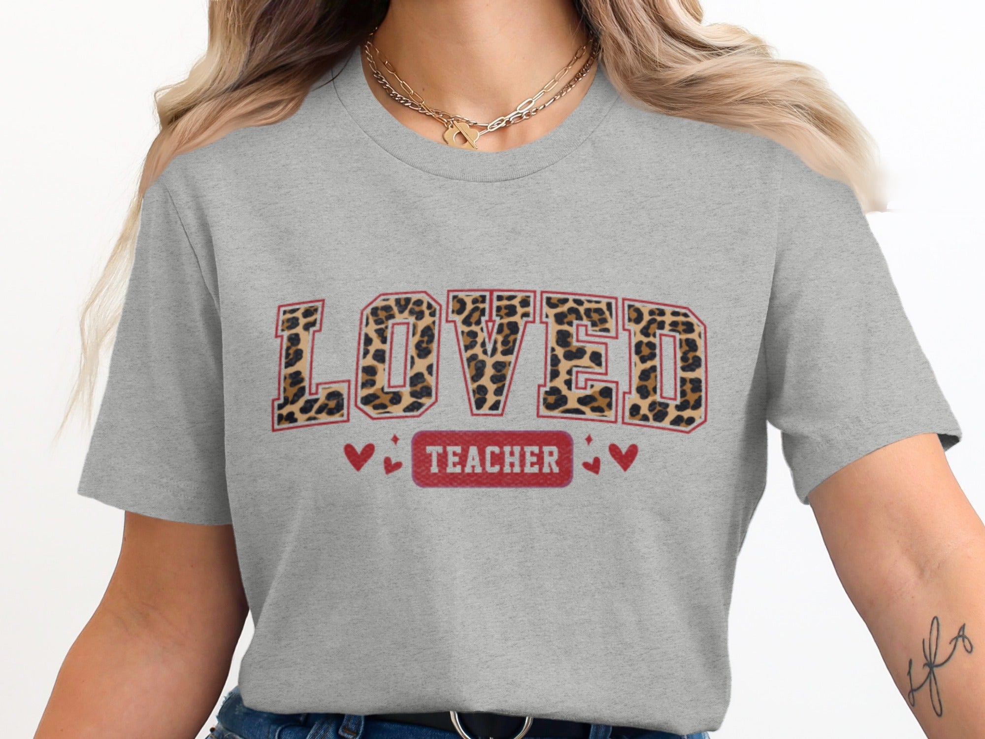 Grey t-shirt with large leopard print letters spelling "LOVED" and "TEACHER" below.