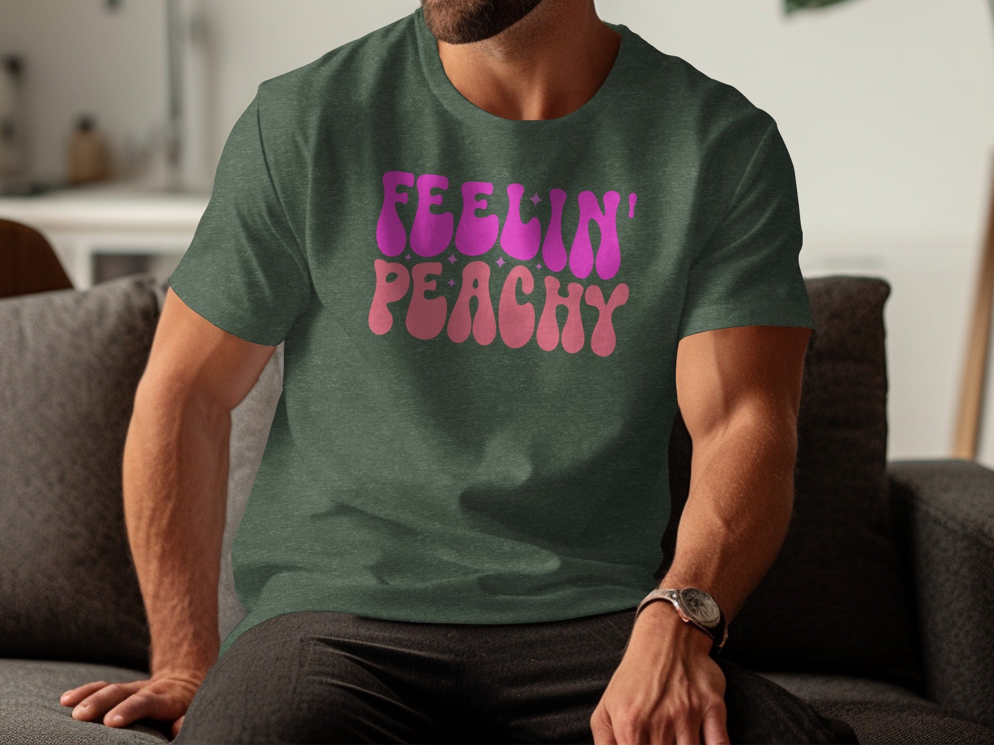 Dark green t-shirt with "Feelin' Peachy" text in pink and peach bubble letters.