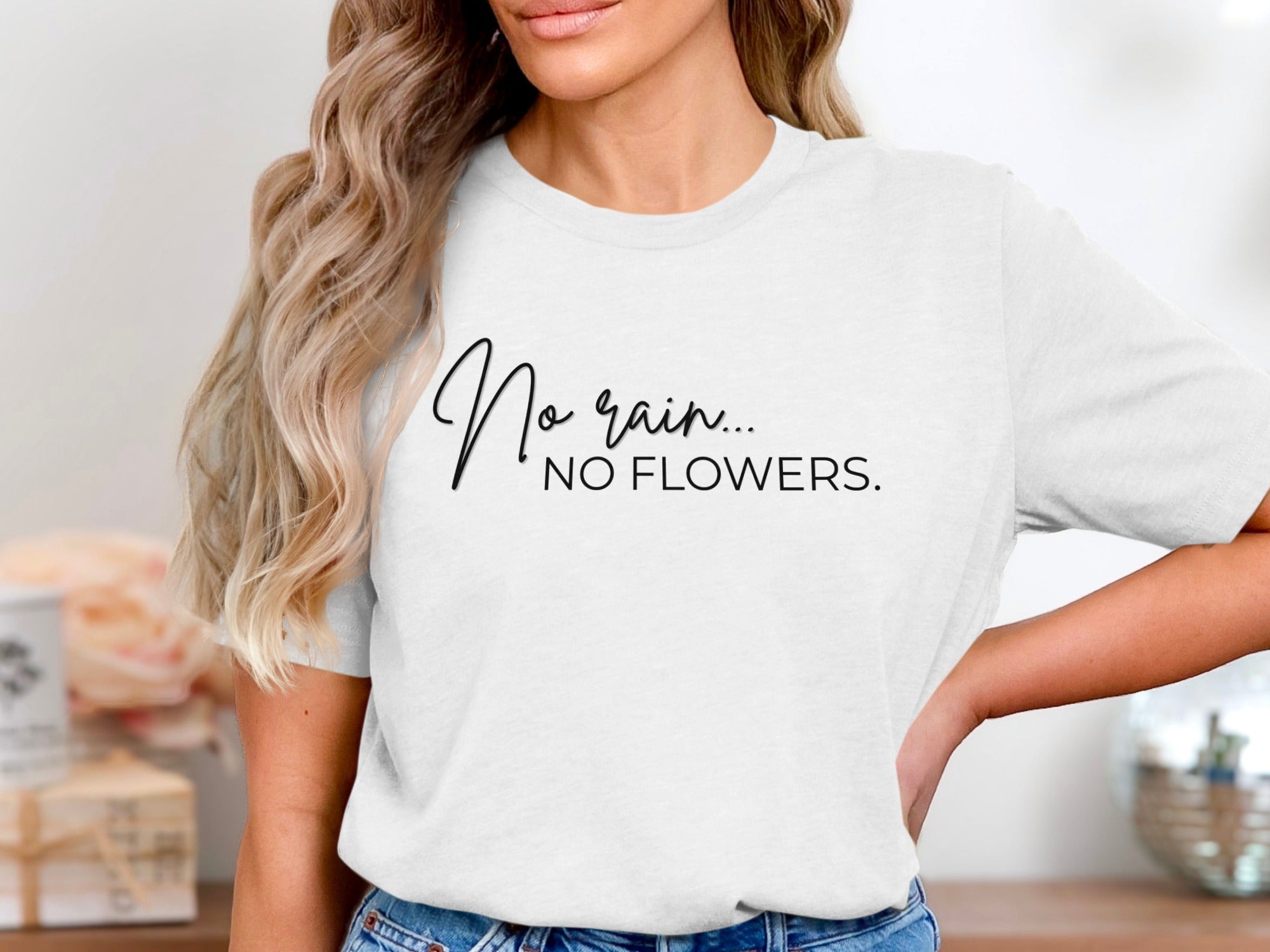White t-shirt with black text: "No rain... NO FLOWERS."
