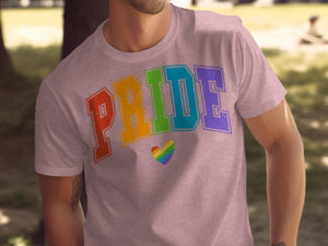 Man wearing a pink t-shirt with rainbow pride lettering and heart graphic.