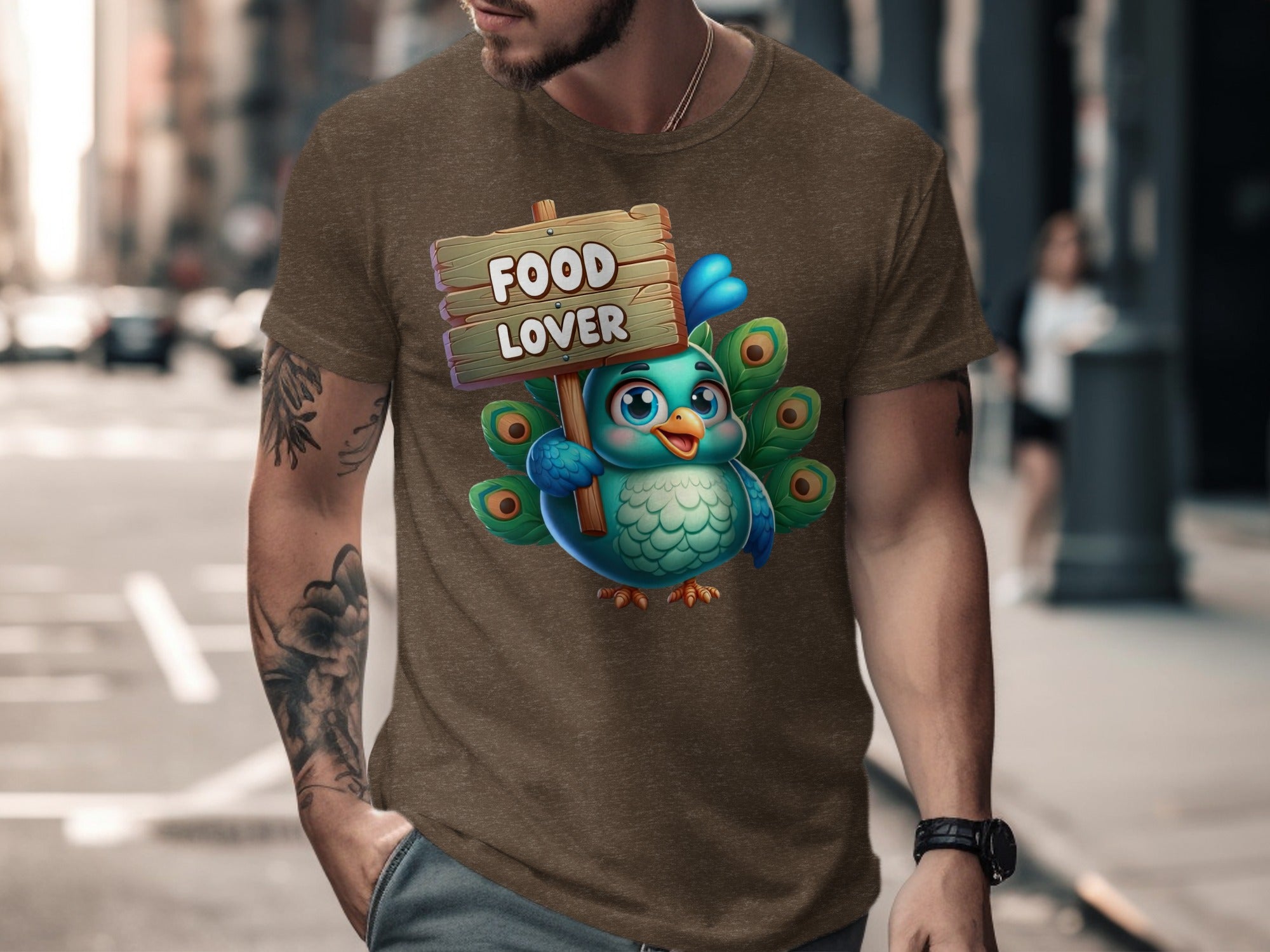 Cartoon peacock holding a "Food Lover" sign, printed on a taupe t-shirt.