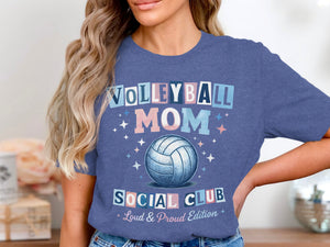 A woman wearing a blue t-shirt featuring a volleyball graphic and the text Volleyball Mom Social Club.