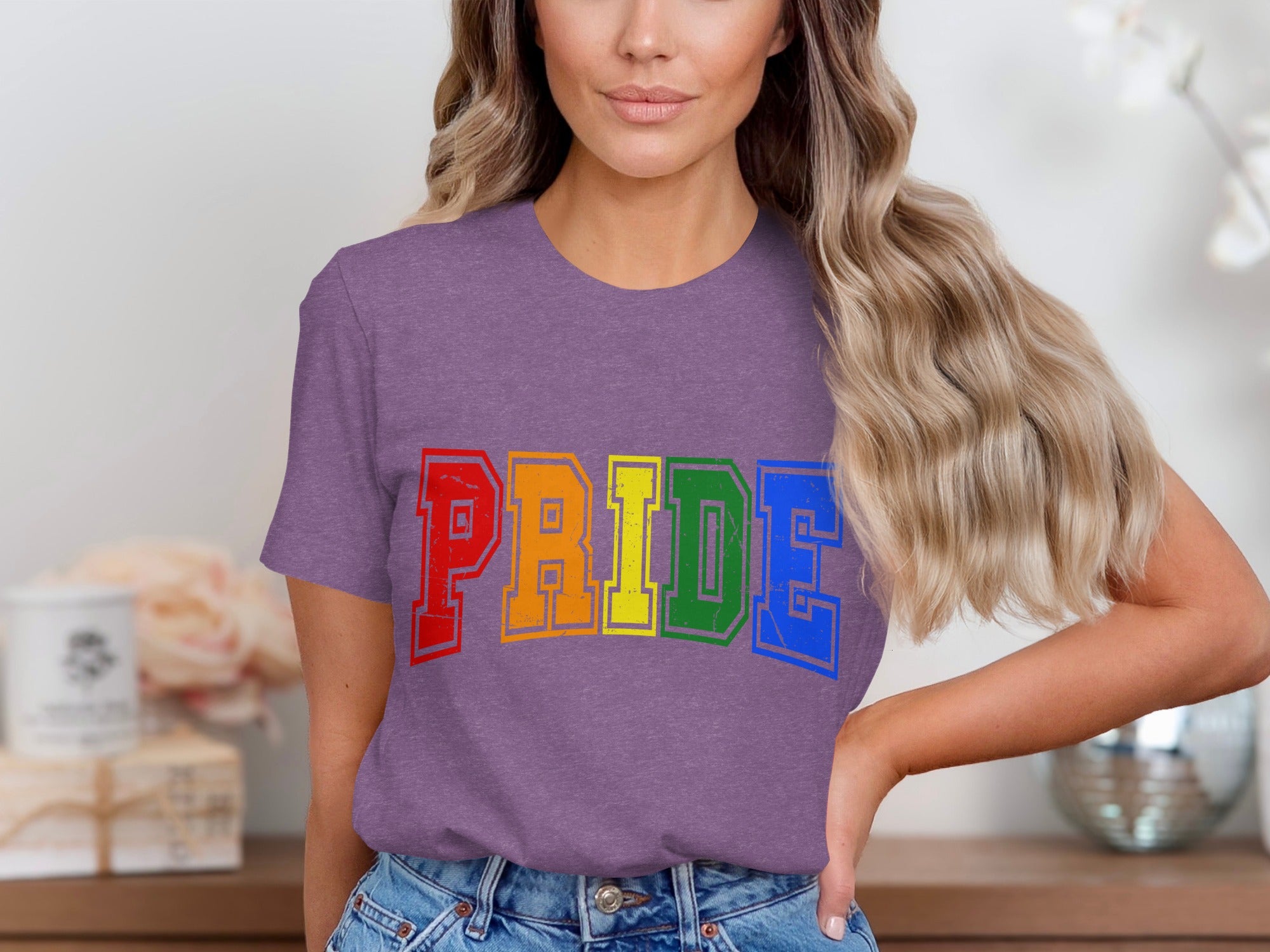 Woman wearing purple t-shirt with "PRIDE" in rainbow block letters