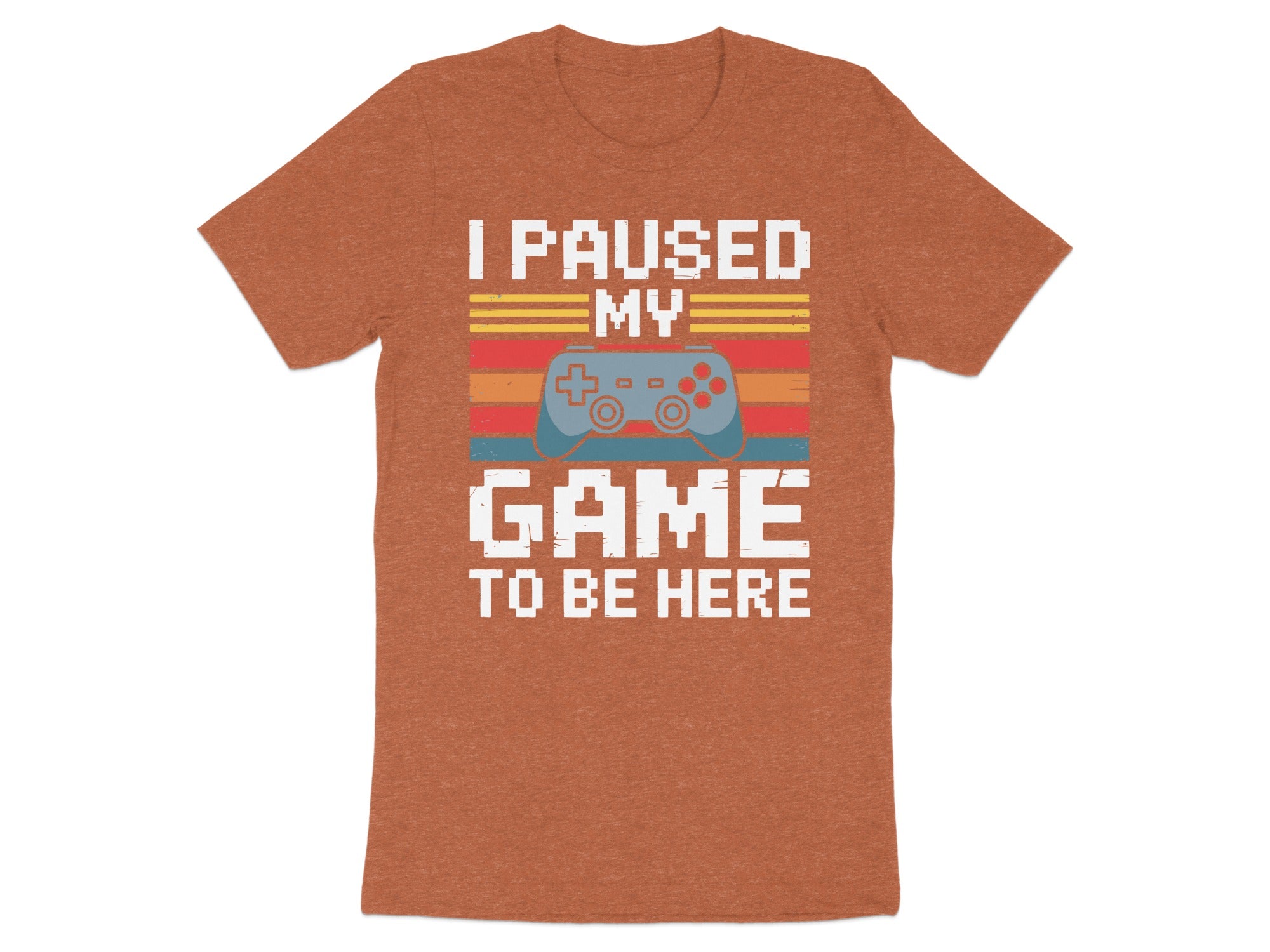 Orange t-shirt with text "I PAUSED MY GAME TO BE HERE" and game controller graphic.