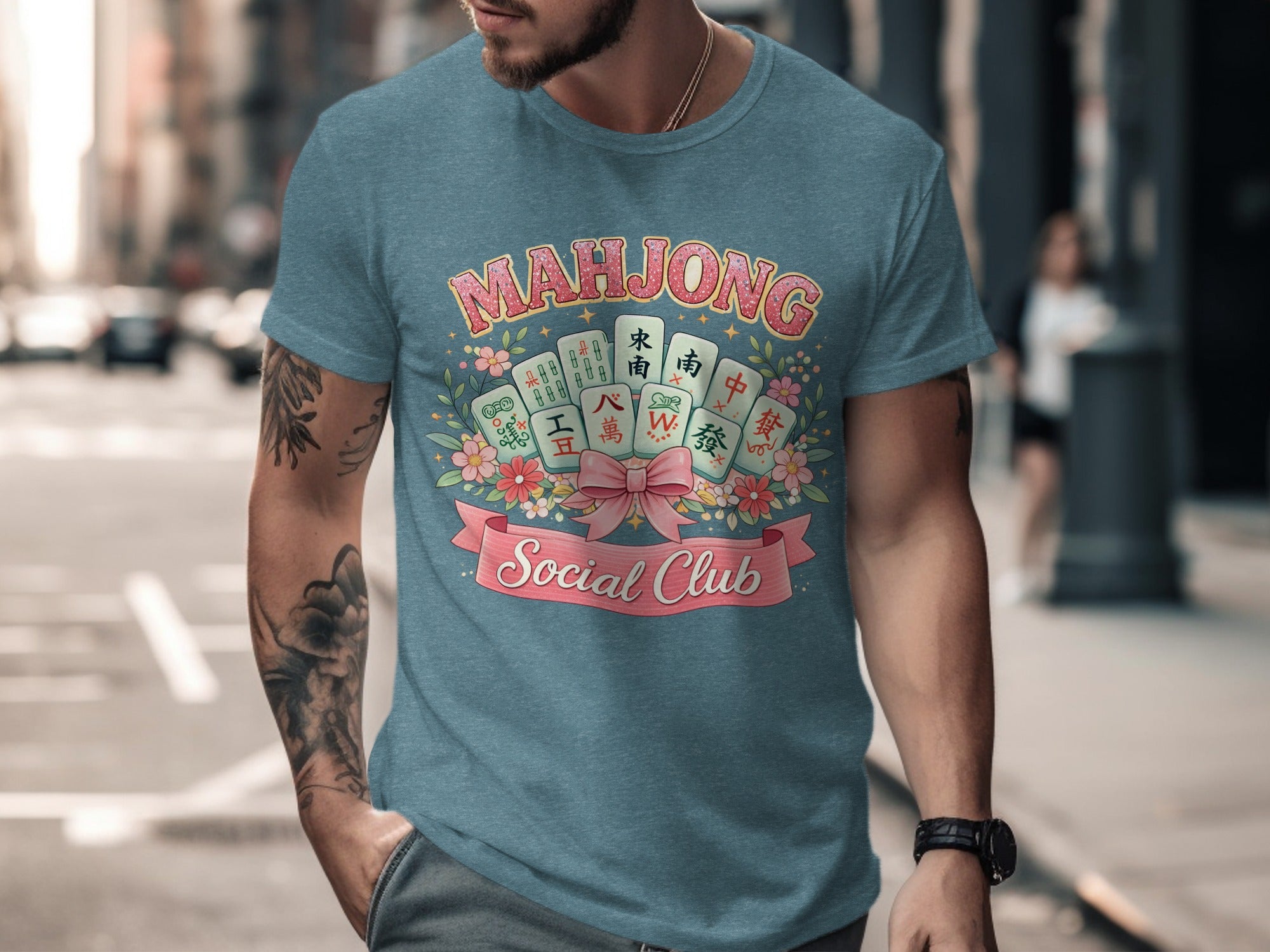 Blue t-shirt with "Mahjong Social Club" text and mahjong tiles surrounded by flowers.