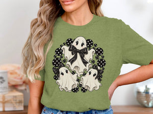Three cute ghosts with black bows surrounded by black and white polka dots.
