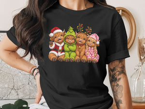 Four Highland cows dressed for Christmas, one in a Santa suit.