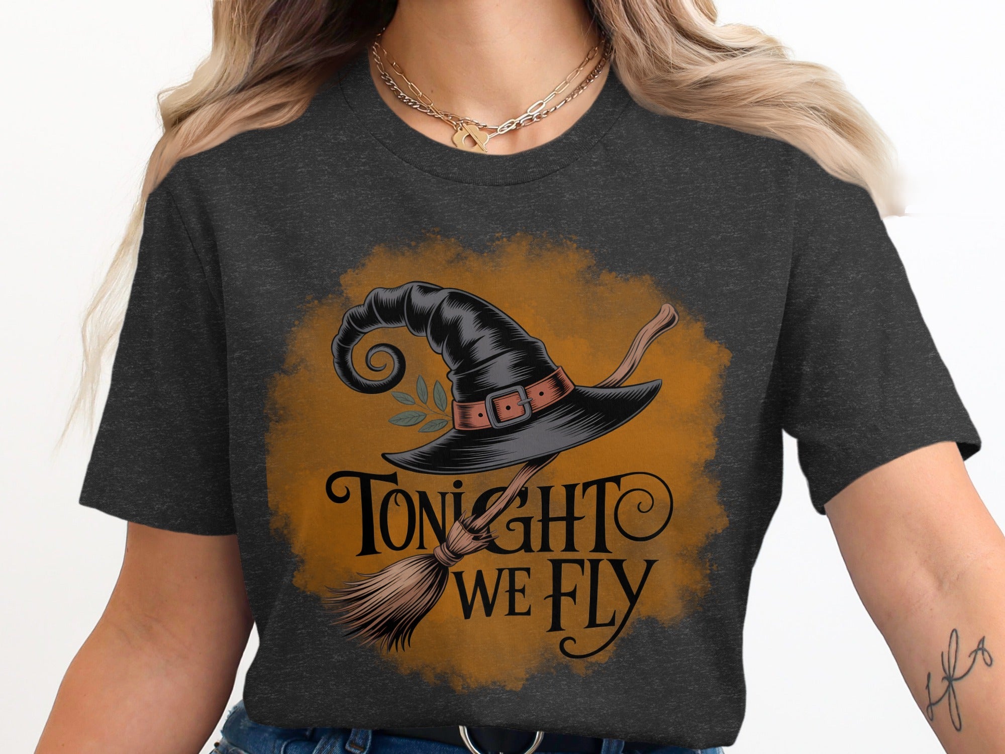 Witch hat and broom graphic with text "Tonight We Fly" on a dark t-shirt.