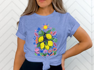 Blue t-shirt with a colorful lemon and floral print and a sun.