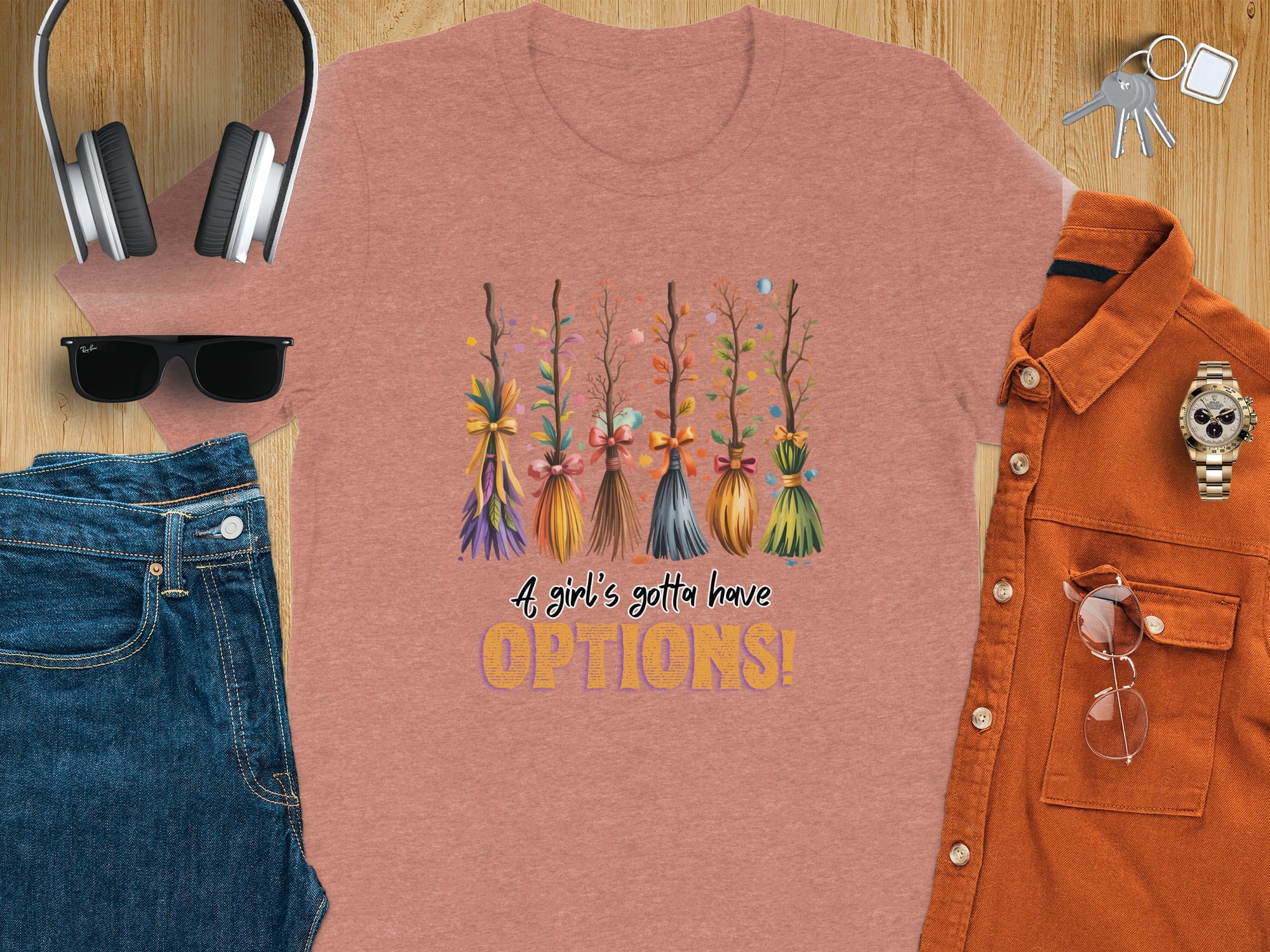 T-shirt with painted brooms and text "A girl's gotta have OPTIONS!"