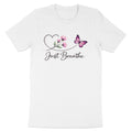 White t-shirt with a pink butterfly, flowers, and "Just Breathe" text.
