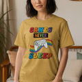Yellow t-shirt with "GAMES NEVER SLEEP" text and rainbow controller graphic.