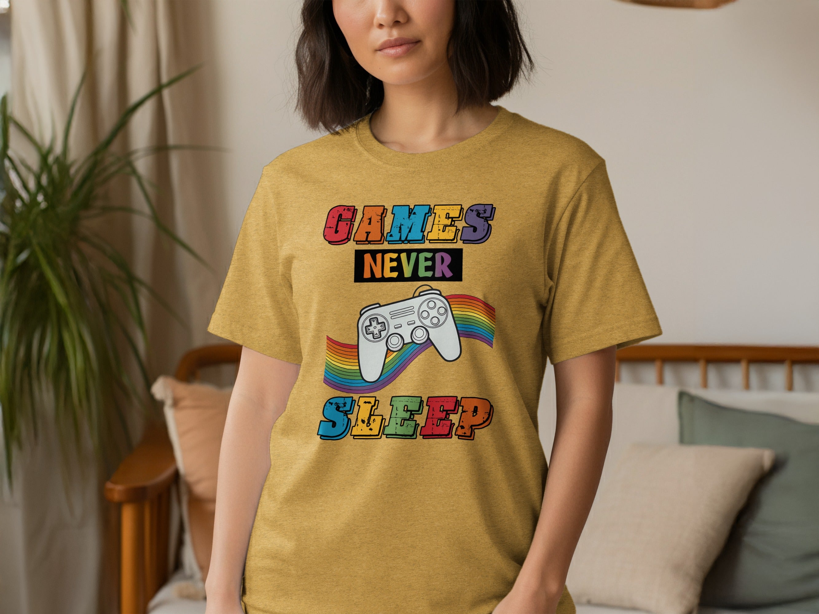 Yellow t-shirt with "GAMES NEVER SLEEP" text and rainbow controller graphic.