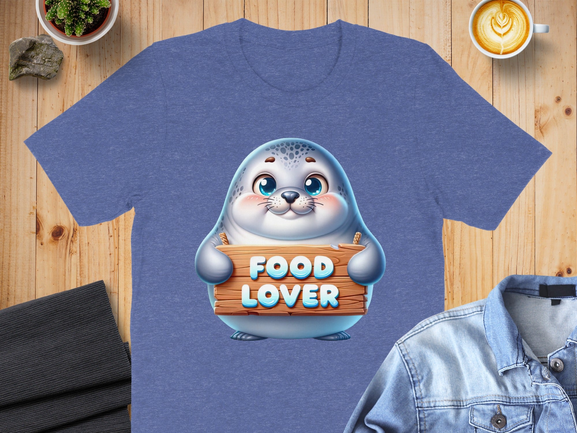Seal graphic with "FOOD LOVER" text on a heathered blue t-shirt.