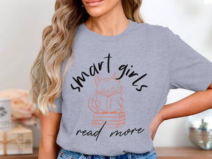Grey t-shirt with text "smart girls read more" and a cat reading on books.