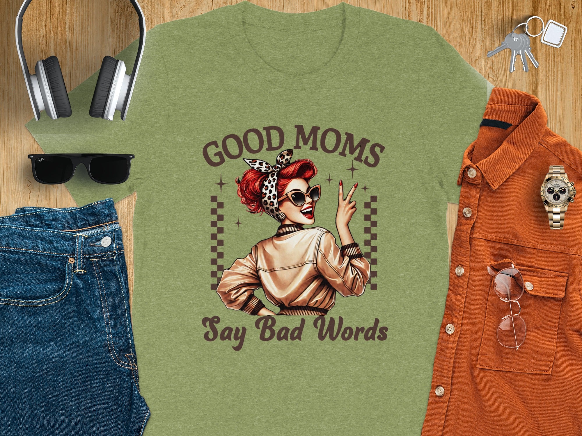 Green t-shirt with woman graphic and text "GOOD MOMS Say Bad Words".