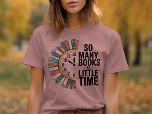 Pink t-shirt with "So Many Books So Little Time" text and book-shaped clock graphic.