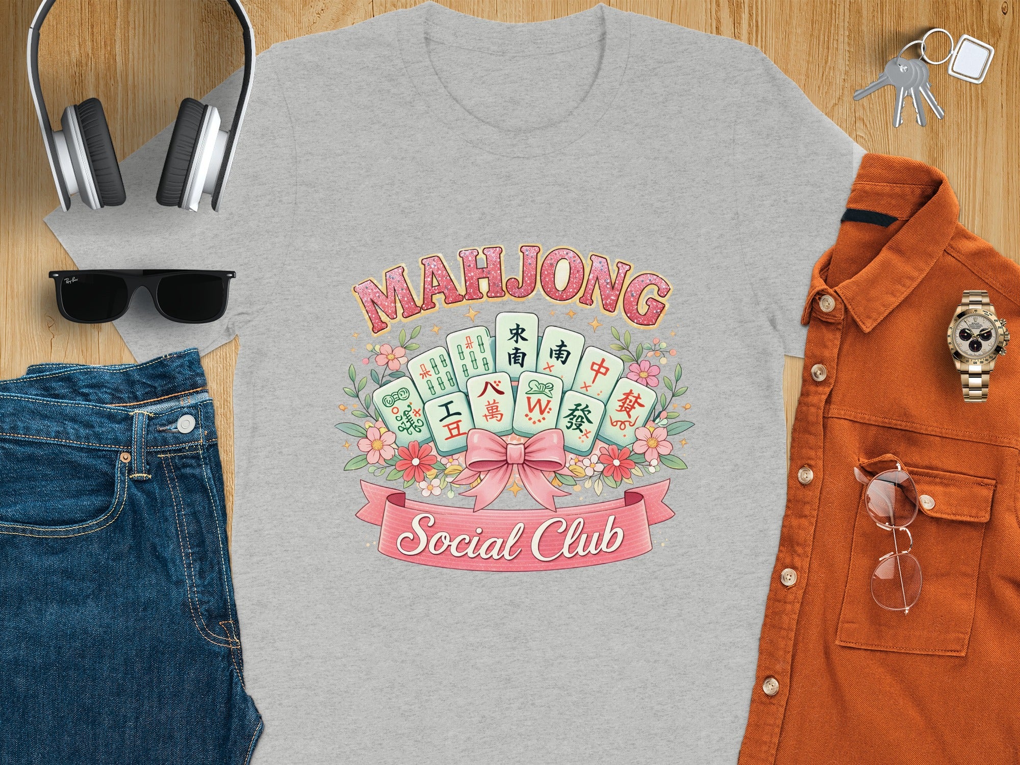 Mahjong Social Club graphic tee with mahjong tiles, flowers, and a pink ribbon.